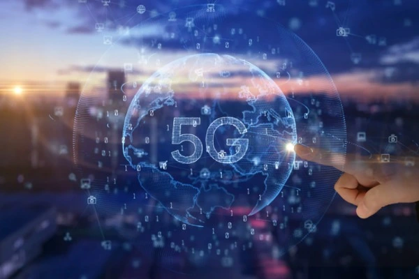 Impact of 5G on Business depicted by a futuristic globe labeled “5G,” surrounded by connectivity icons against a modern city backdrop.